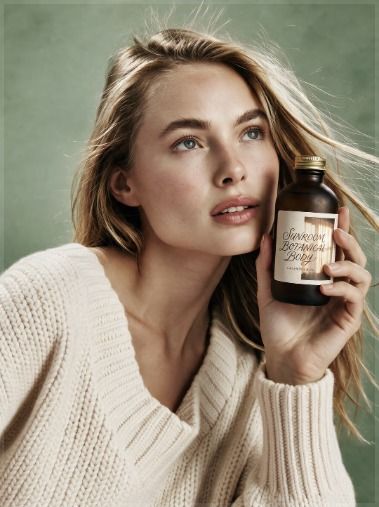 Model with a body oil bottle