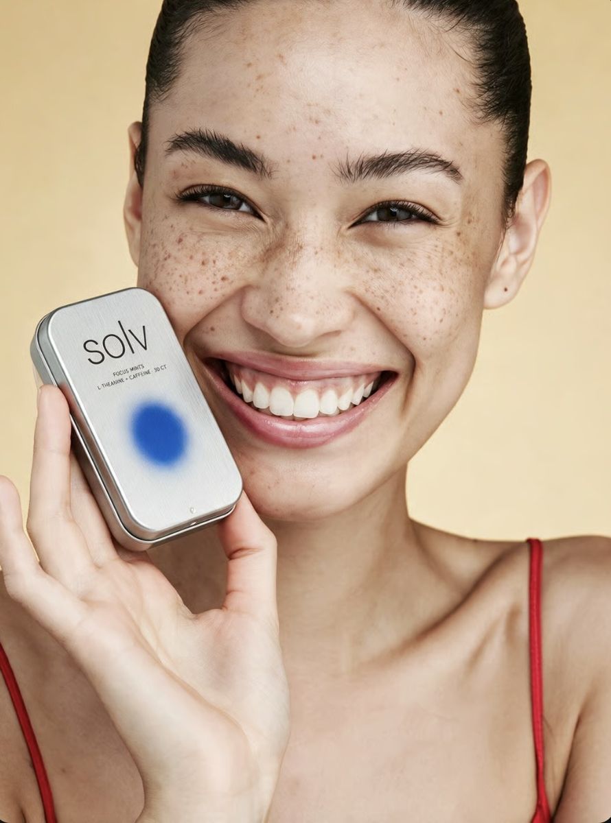 Model holding a tin of mints